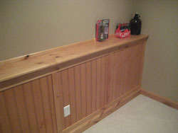 A custom wooden countertop along a green wall